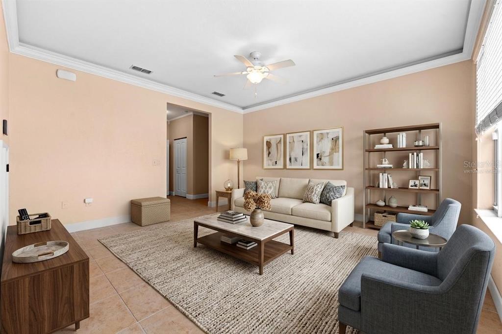A living room features a beige sofa, two blue armchairs, and a coffee table — 231 ALEXANDER WOODS DRIVE, PLANT CITY, FL