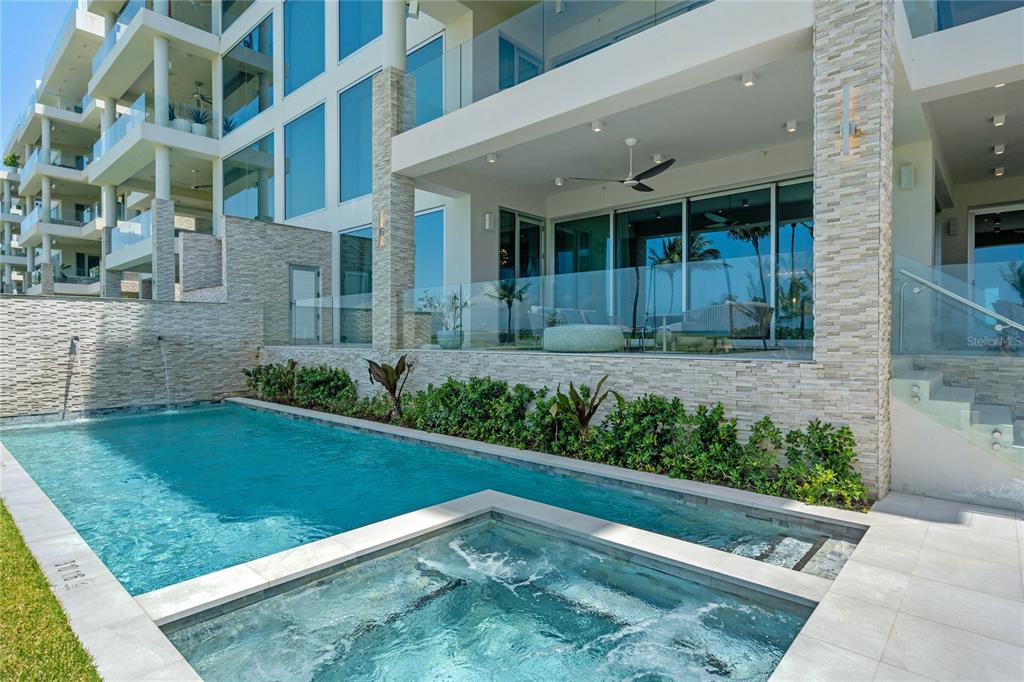 A modern patio features a swimming pool, a hot tub, and glass railings overlooking the ocean — Bahia Beach Resort OCEAN DRIVE UNIT 3102, RIO GRANDE, PR