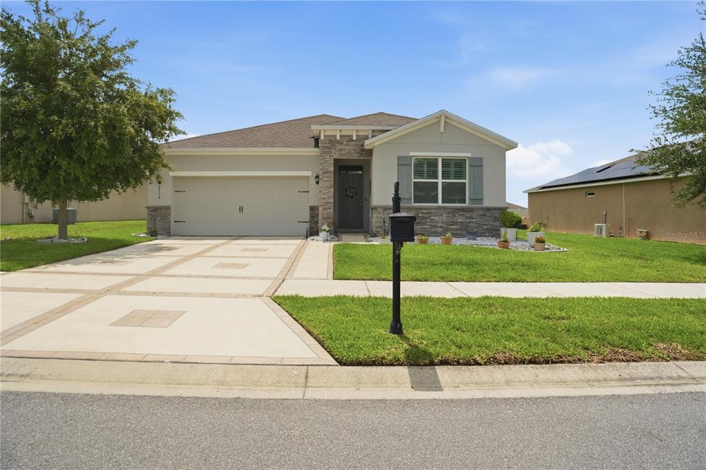A single-story house with a stone facade, a two-car garage, and a paved driveway — 9152 SW 60TH COURT ROAD, OCALA, FL
