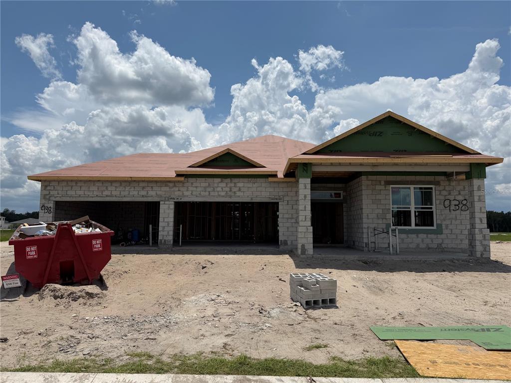 This is a digital rendering of a single-story house with a three-car garage — 938 MEGANO BOULEVARD, DELAND, FL