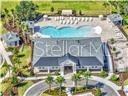 An aerial view shows a community clubhouse with a swimming pool and surrounding lounge chairs — 938 MEGANO BOULEVARD, DELAND, FL