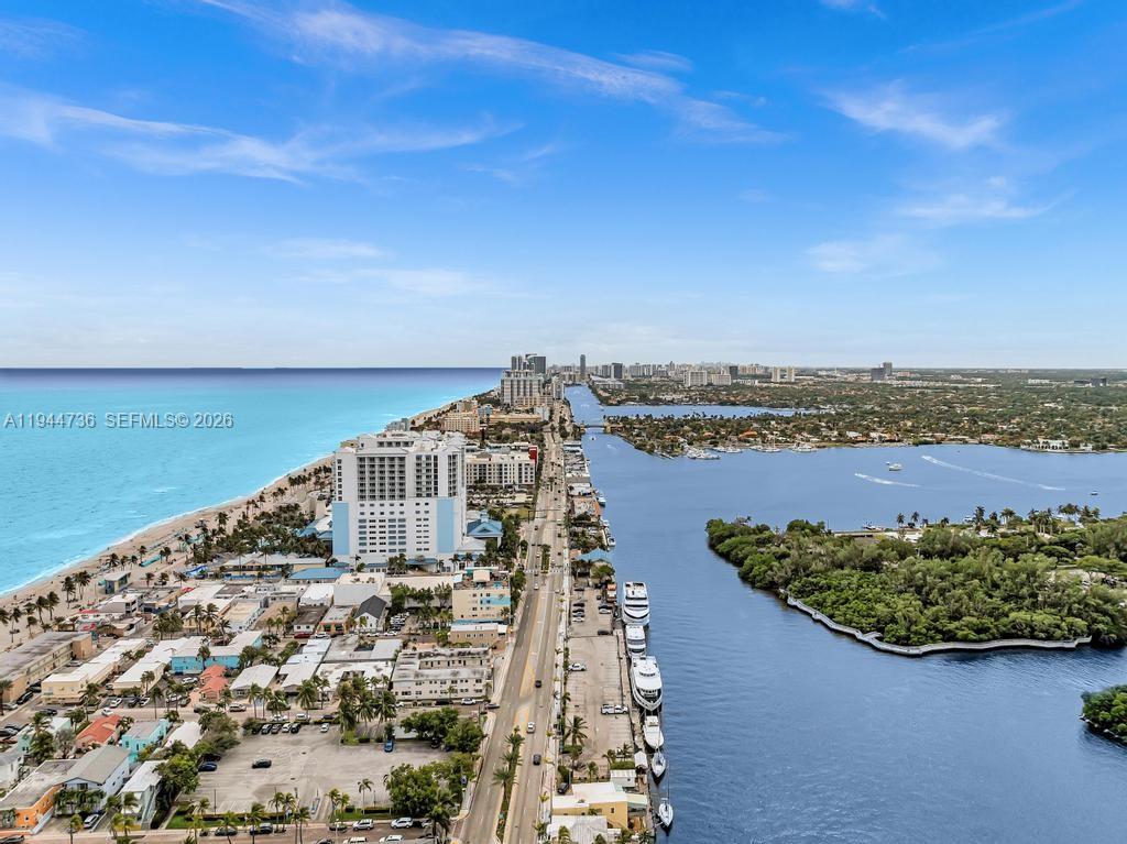 An aerial view shows a coastal road separating the ocean beach from a bay — 1318 N Ocean Dr, Hollywood FL 33019, HOLLYWOOD, FL