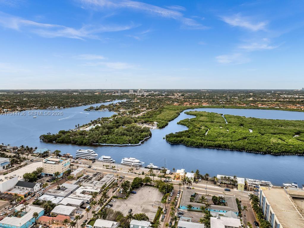 An aerial view shows a waterway with docked yachts, mangrove islands, and surrounding coastal buildings — 1318 N Ocean Dr, Hollywood FL 33019, HOLLYWOOD, FL