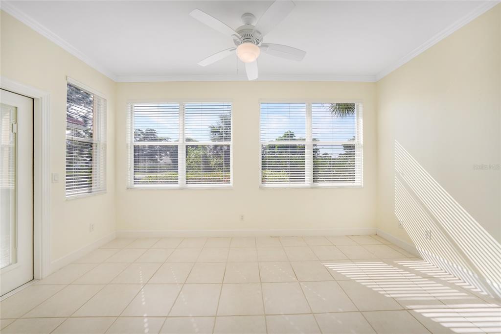 A sunroom with white tile flooring, a ceiling fan, and large windows with blinds — 3810 COBIA VILLAS COURT, PUNTA GORDA, FL