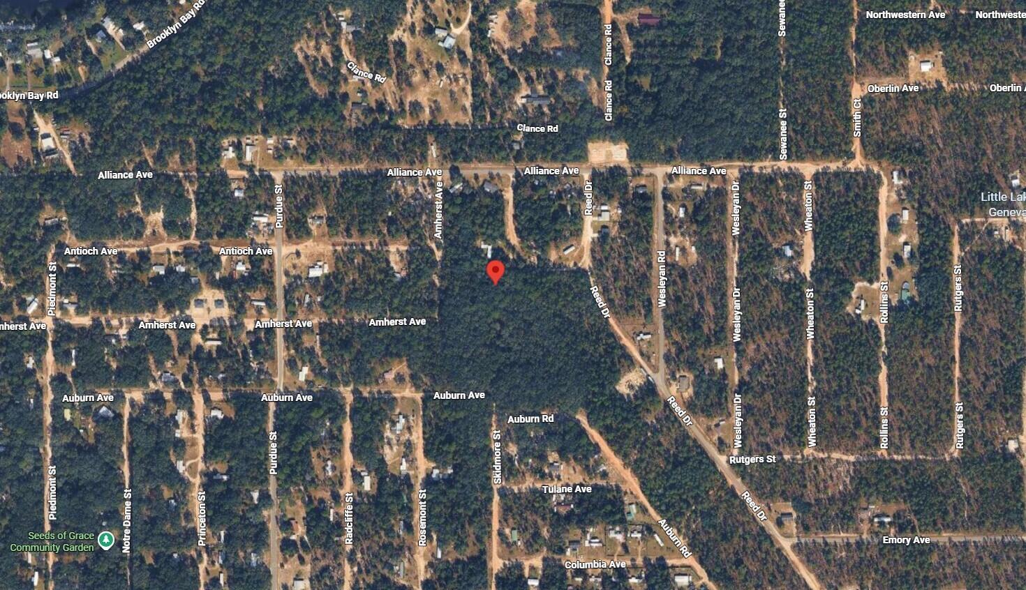 This is an aerial map view of a wooded residential area with a red location pin — 7152 Knox Street, FL 32656, FL