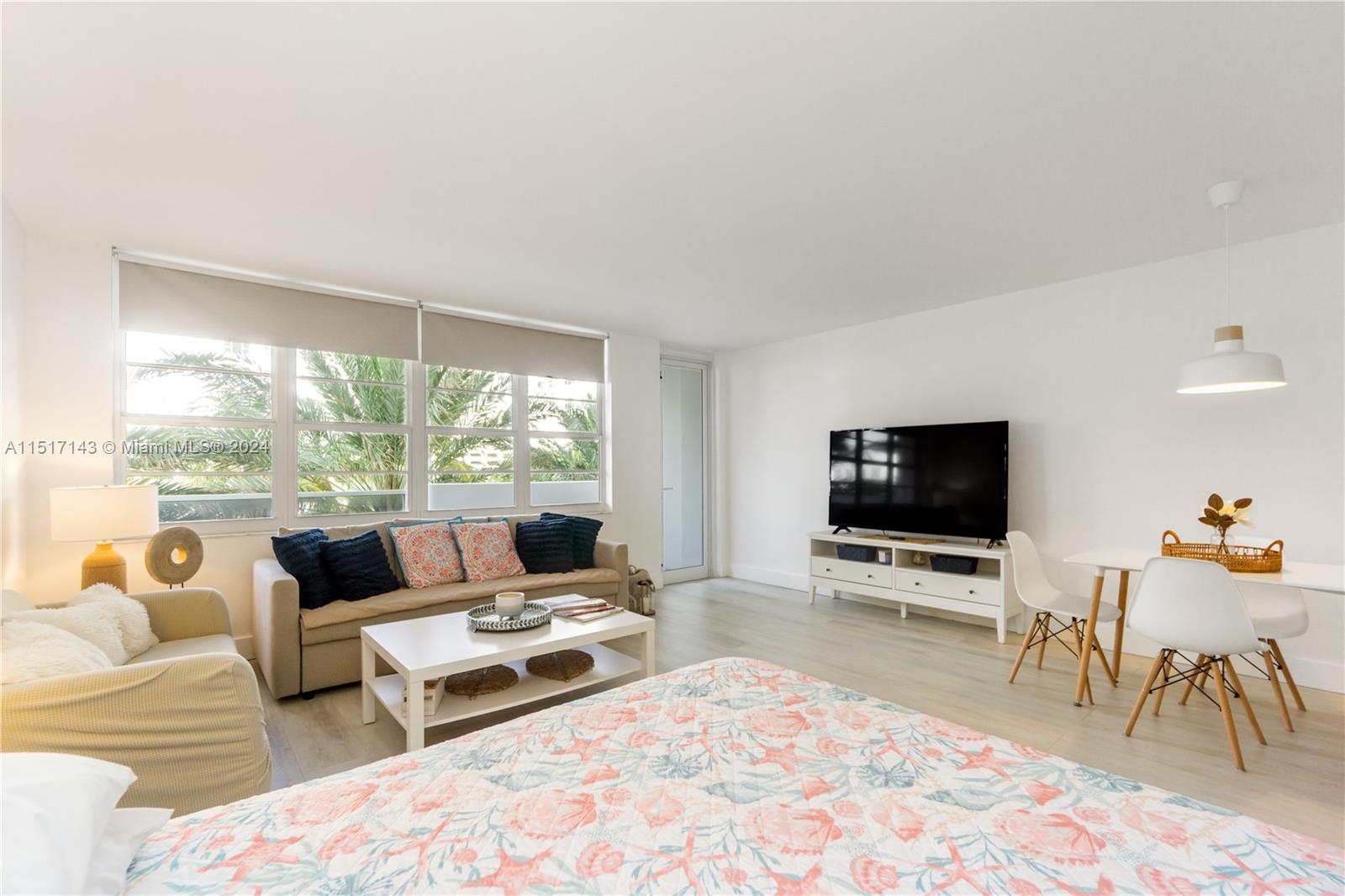 This studio apartment features a living area, dining space, and bed with light wood flooring — 100 Lincoln Rd # 312, Miami Beach FL 33139, MIAMI BEACH, FL