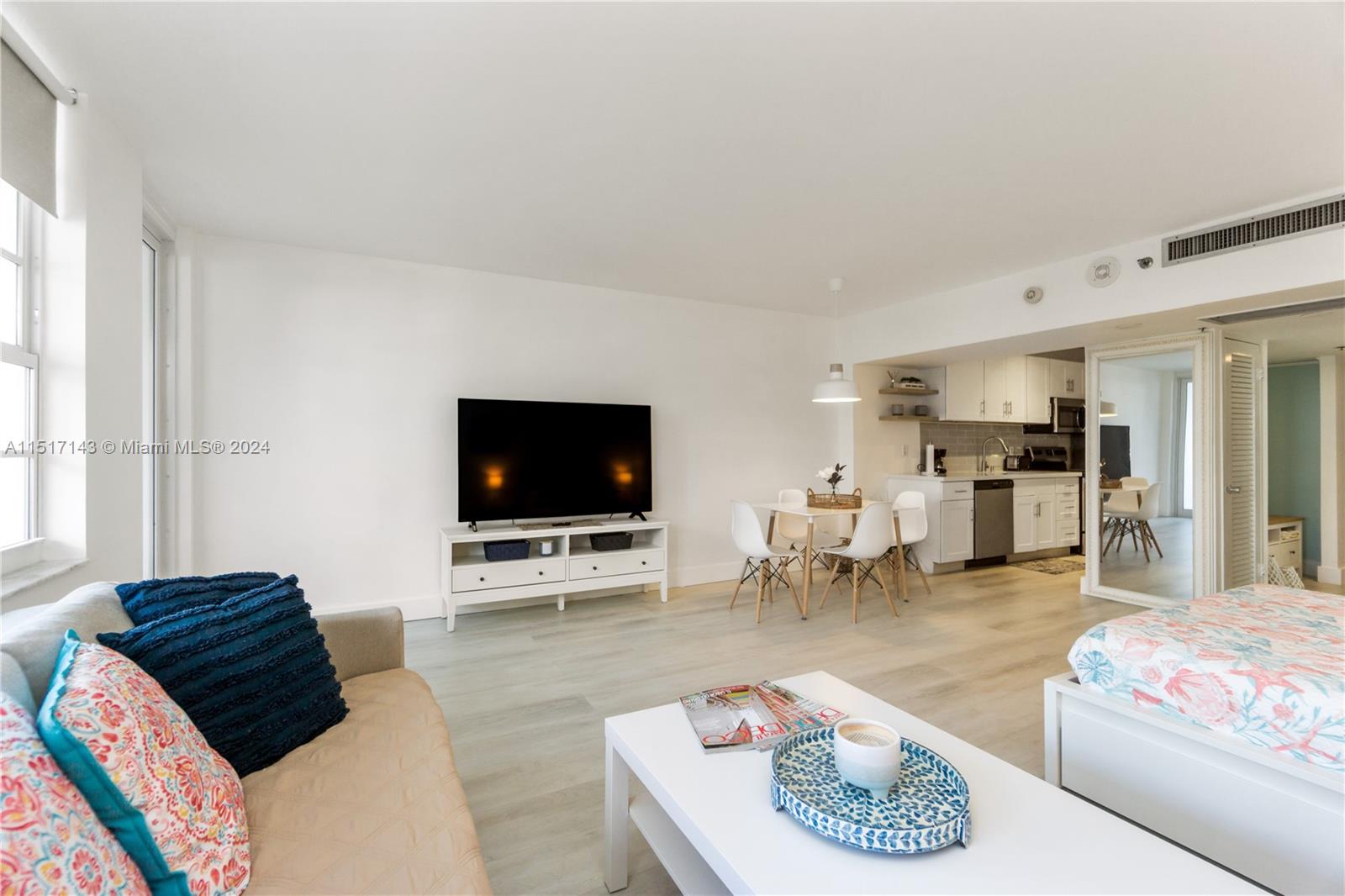 This studio apartment features a living area, dining space, and kitchen with light wood flooring — 100 Lincoln Rd # 312, Miami Beach FL 33139, MIAMI BEACH, FL