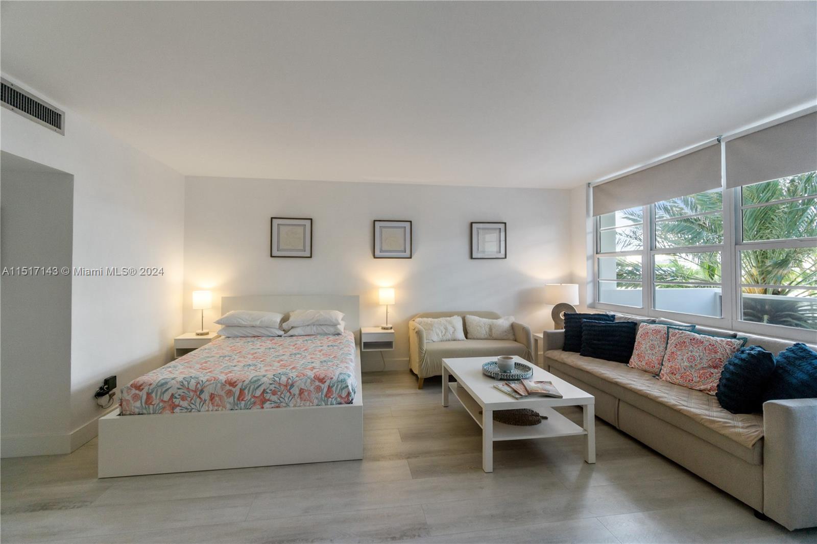 A studio apartment features a bed, a sofa, a coffee table, and large windows — 100 Lincoln Rd # 312, Miami Beach FL 33139, MIAMI BEACH, FL
