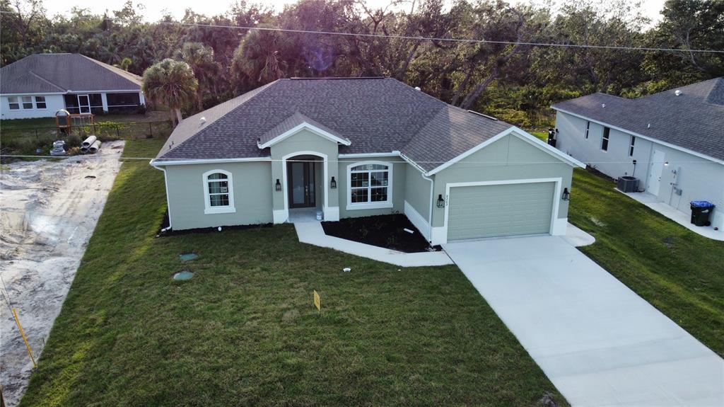 An unfinished room shows exposed wooden roof trusses, HVAC ductwork, and electrical wiring — 8233 GIVLIC LANE, NORTH PORT, FL