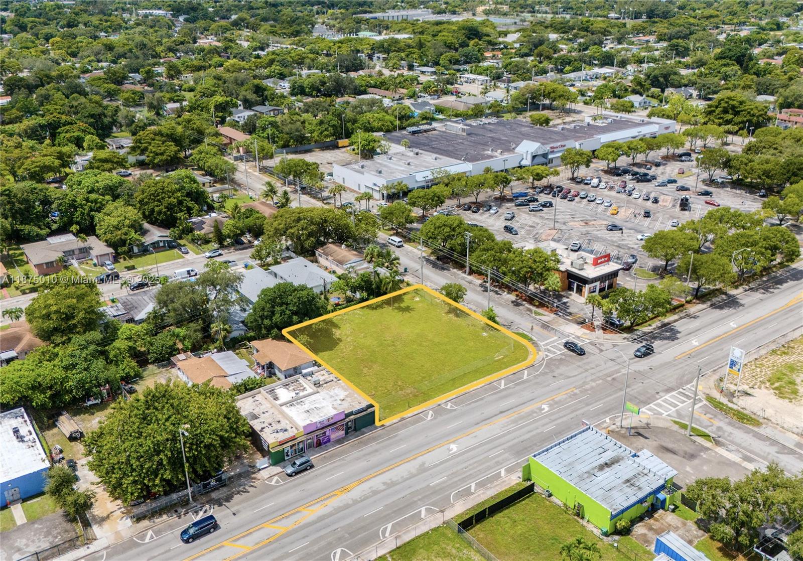 An aerial view shows a vacant, rectangular grass lot situated next to a commercial building — 1090 NW 54th St, Miami FL 33127, MIAMI, FL