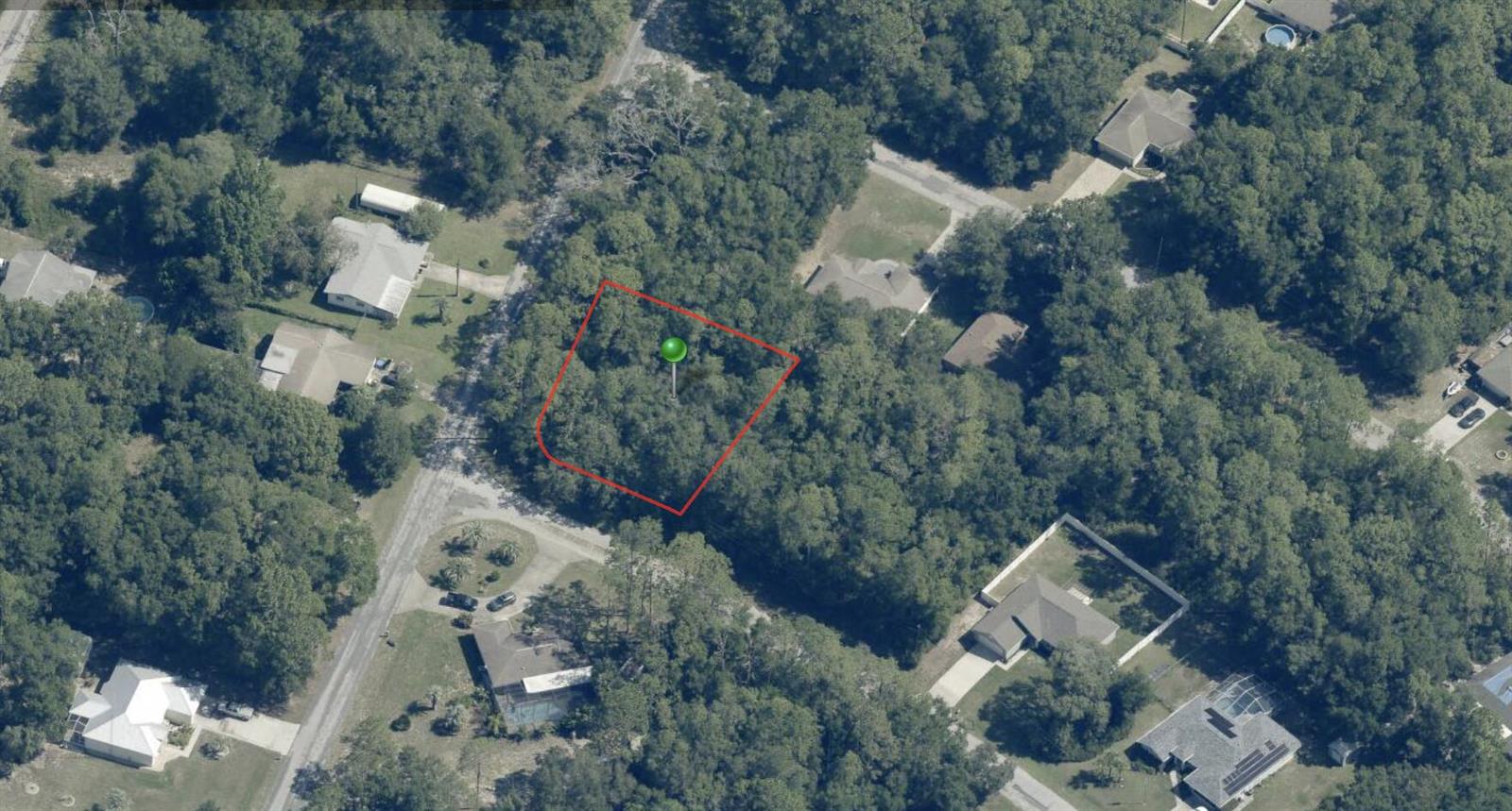 An aerial view shows a wooded, rectangular plot of land outlined in red — 9759 N Kendall Way, FL 34434, FL