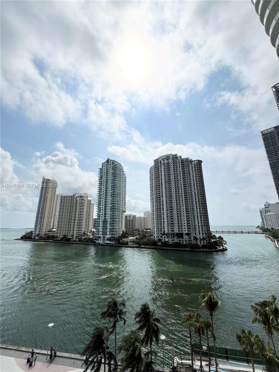 A view of high-rise residential buildings on a waterfront island under a cloudy sky — 300 S Biscayne Blvd # 814, Miami FL 33131, MIAMI, FL