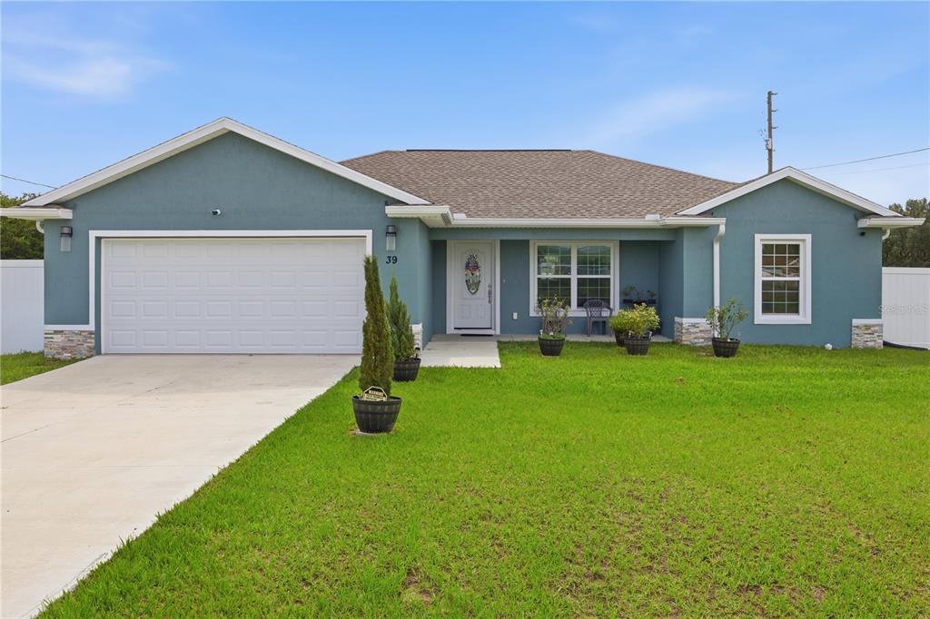 An aerial view shows a single-story house with a fenced yard along a paved road — 39 DOGWOOD TRAIL, OCALA, FL