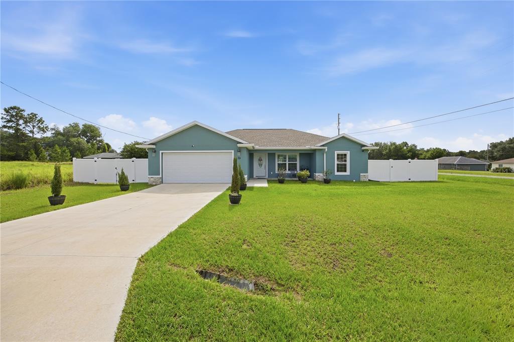 An aerial view shows a single-family house with a fenced yard near a paved road — 39 DOGWOOD TRAIL, OCALA, FL