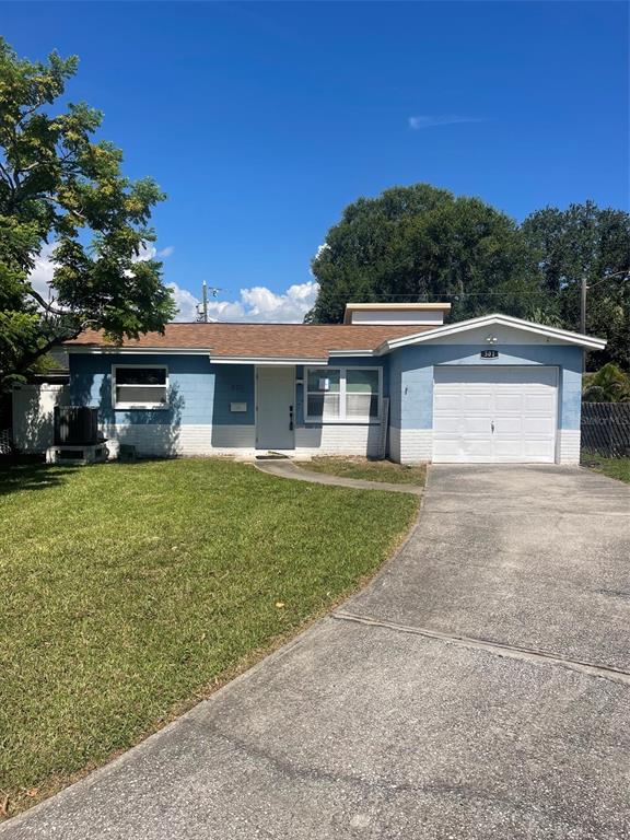 A backyard features a brick patio, a stone walkway, and a white vinyl privacy fence — 501 PALM AVENUE N, ST PETERSBURG, FL