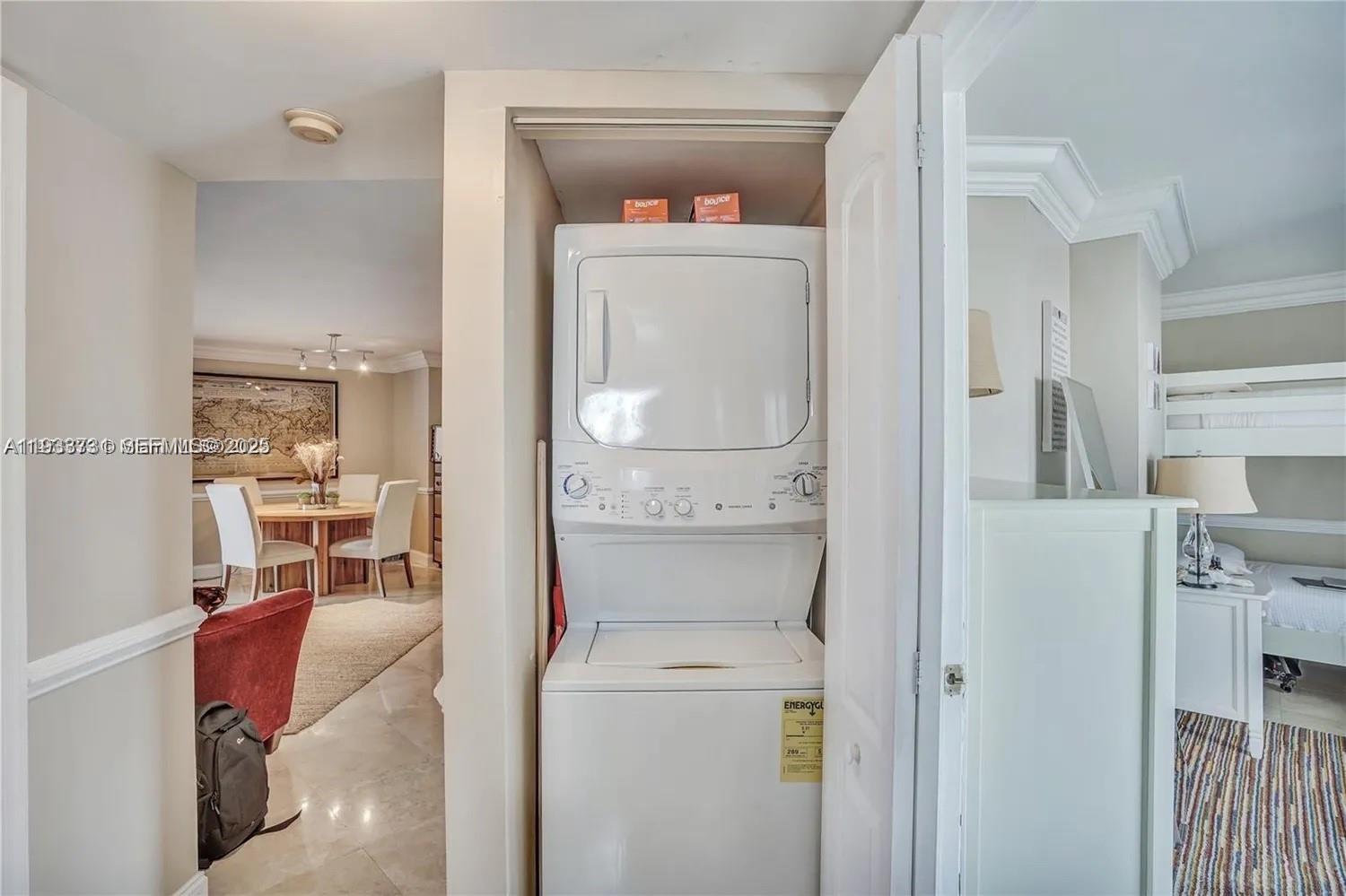 A stacked washer and dryer unit is located in a closet between two rooms — 6767 Collins # 901, Miami Beach FL 33141, MIAMI BEACH, FL