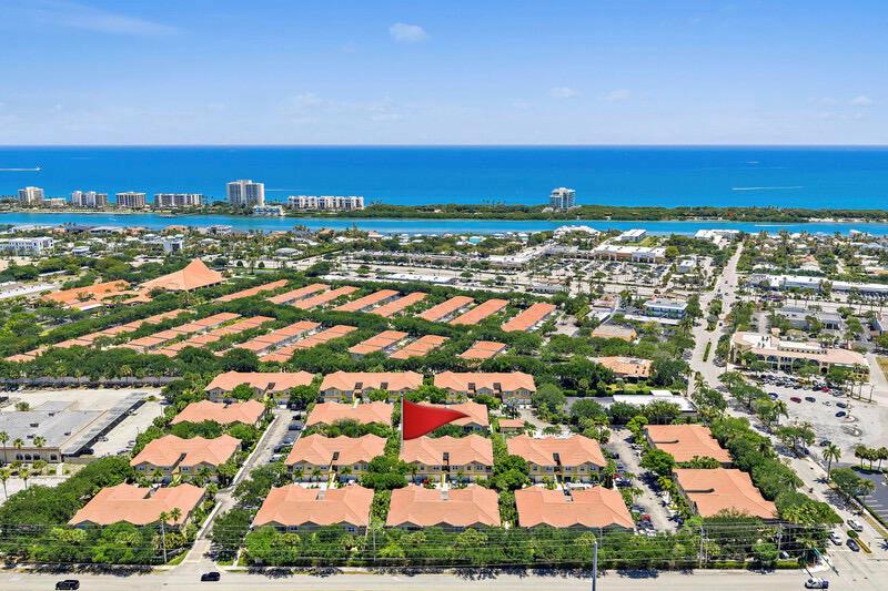 Aerial view of a residential complex with red-tiled roofs near a coastal waterway and ocean — 114 Lighthouse Circle Unit C, Tequesta FL 33469, TEQUESTA, FL