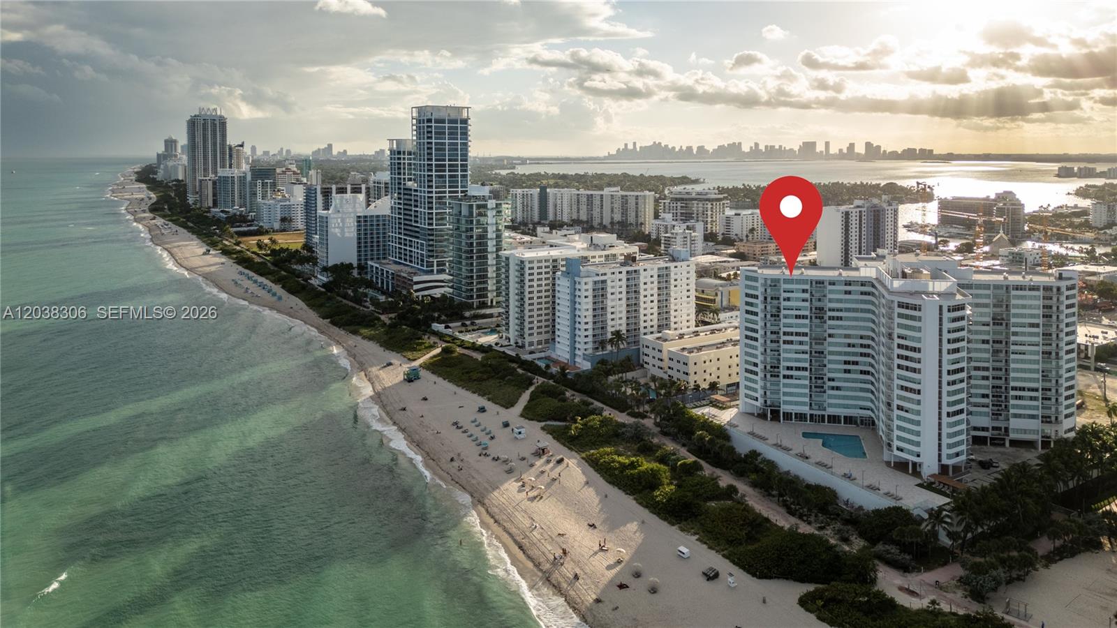 An aerial view of a beachfront high-rise condominium building with a red location pin — 7135 Collins Ave # 1216, Miami Beach FL 33141, MIAMI BEACH, FL