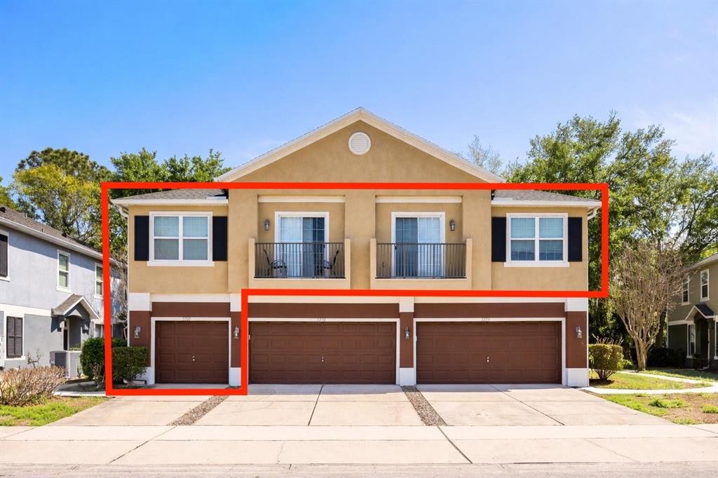 The exterior of a multi-unit residential building features three garage doors and two upper balconies — 2210 SAN JACINTO CIRCLE, SANFORD, FL