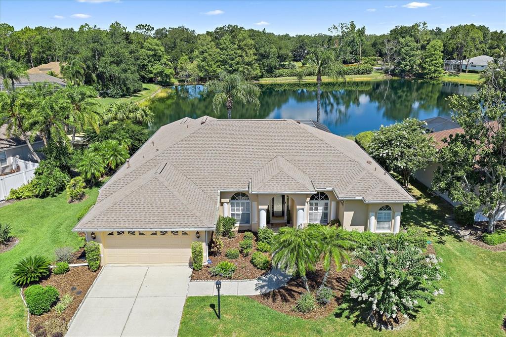 An aerial view of a single-story suburban house with a garage, driveway, and backyard lake — 11909 SUMMER MEADOW DRIVE, LAKEWOOD RANCH, FL
