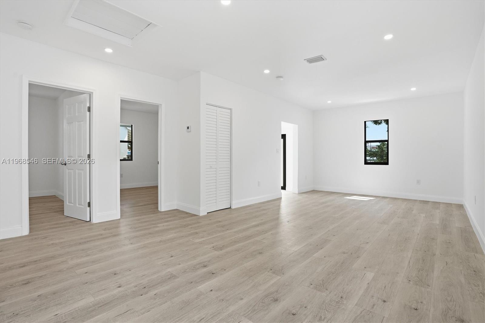A bright, empty room features white walls, light wood-look flooring, and recessed ceiling lighting — 4237 SW 7th St, Miami FL 33134, MIAMI, FL