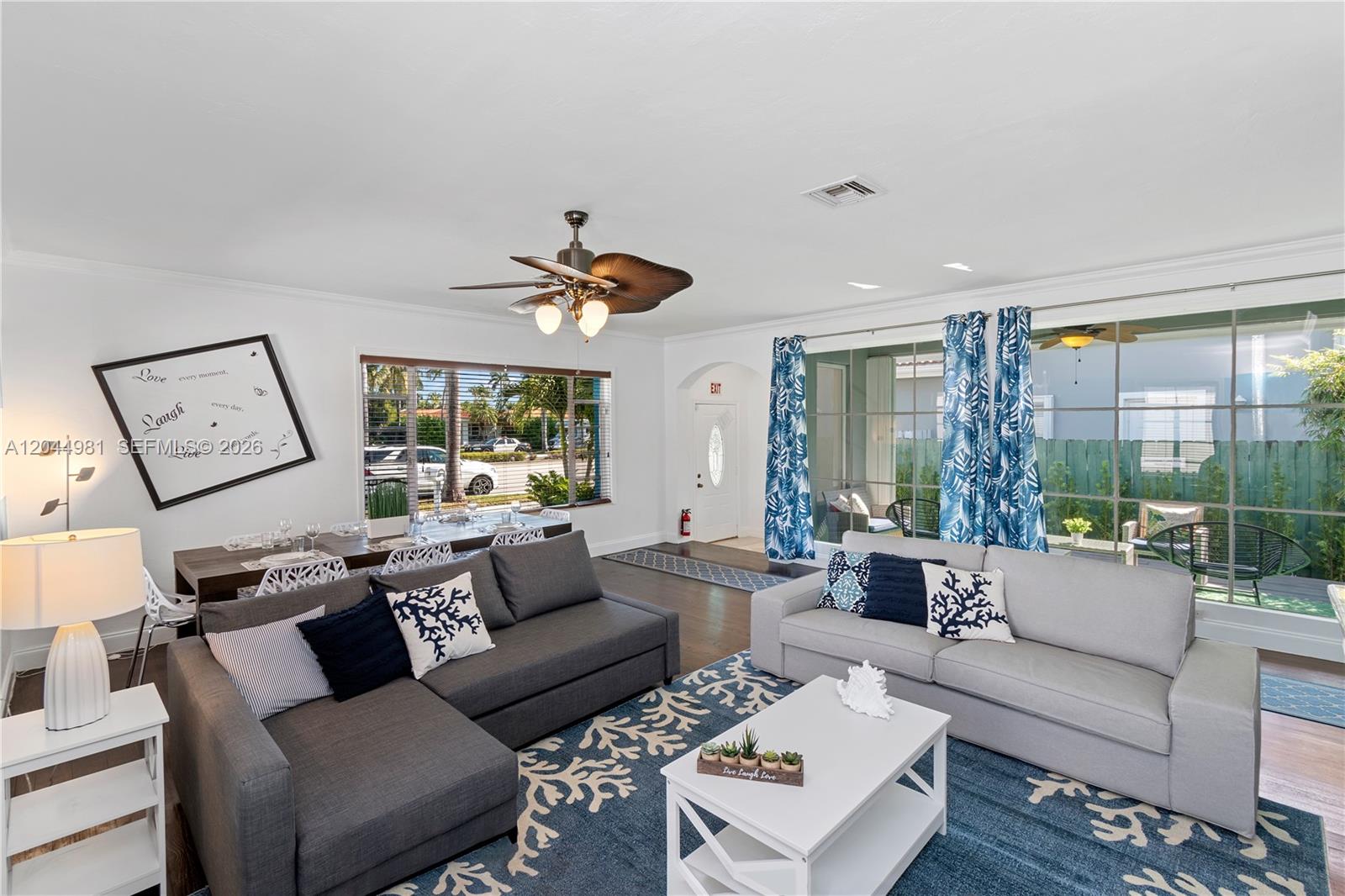 A living room features a grey sectional sofa, a coffee table, and a dining area — 1446 Hollywood Blvd, Hollywood FL 33020, HOLLYWOOD, FL