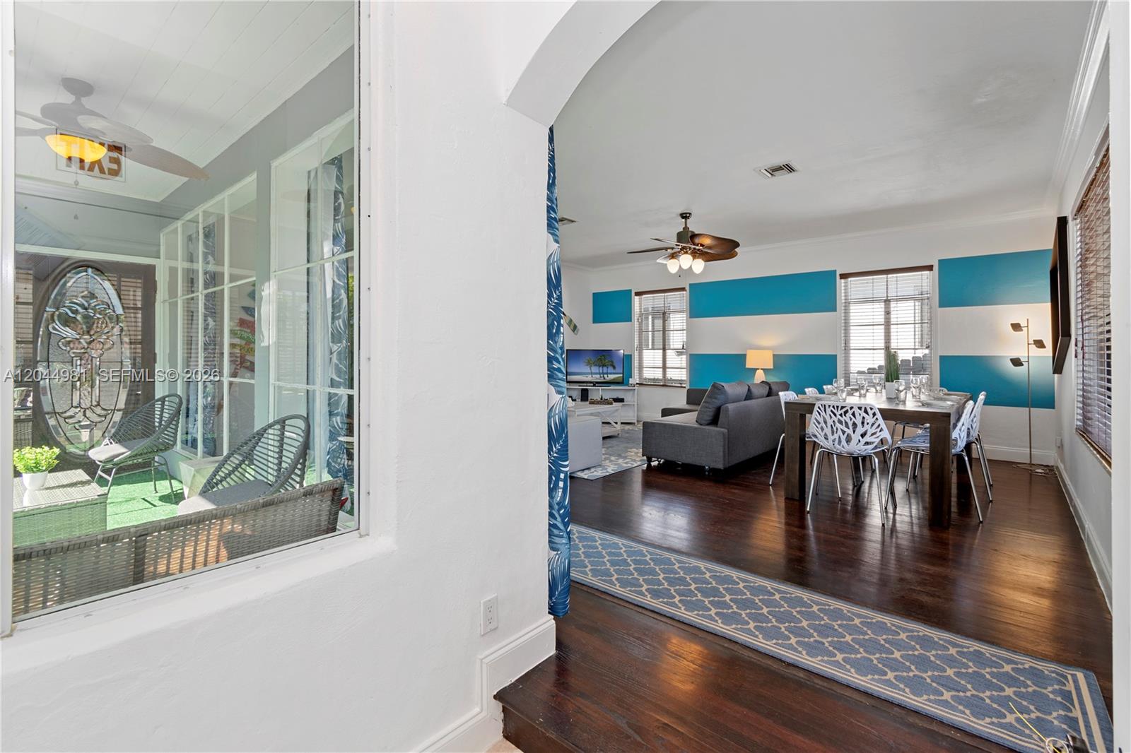 A view from a sunroom into a living and dining area with striped walls — 1446 Hollywood Blvd, Hollywood FL 33020, HOLLYWOOD, FL