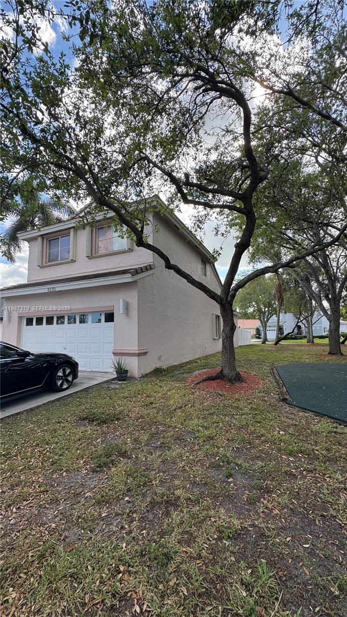 A two-story house with a light-colored stucco exterior and a white garage door — 4220 SW 153rd Ave, Miramar FL 33027, MIRAMAR, FL