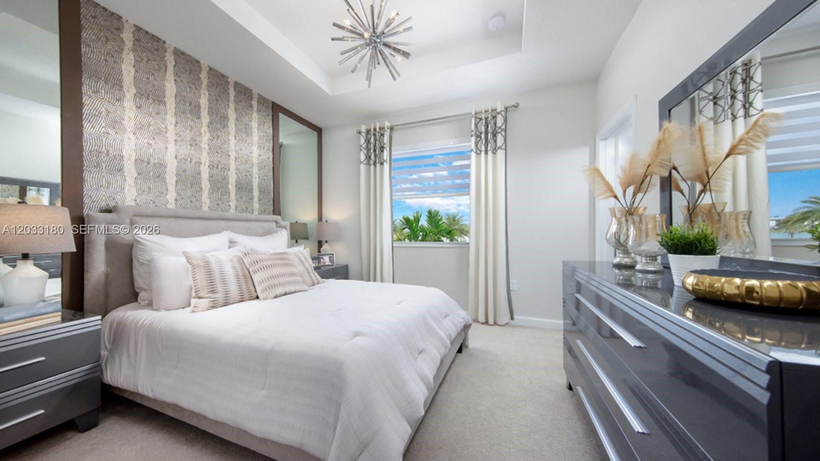 A bedroom features a patterned accent wall, a gray bed, and a modern ceiling fixture — 2592 SE 25 RD, Homestead FL 33035, HOMESTEAD, FL