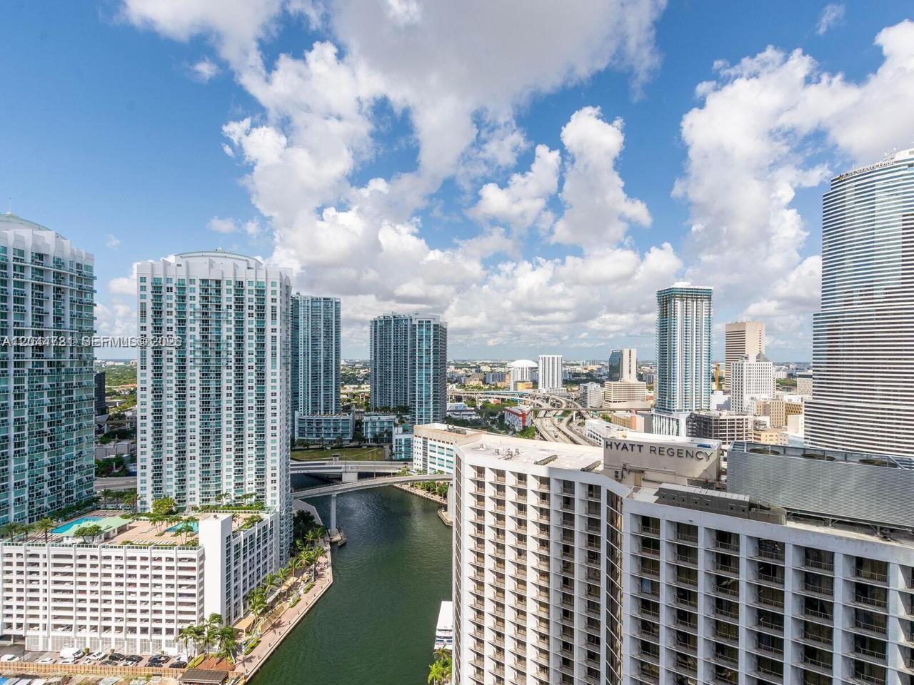 An elevated view of a city skyline featuring high-rise buildings, a river, and bridges — 200 Biscayne Boulevard Way # 3102, Miami FL 33131, MIAMI, FL