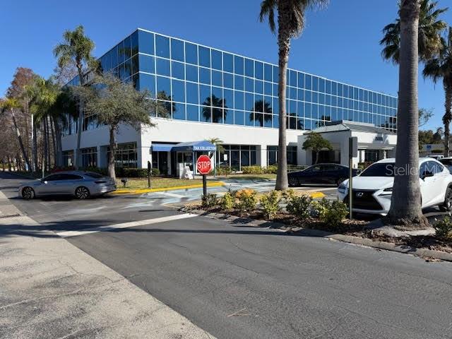 A multi-story office building with a glass facade stands behind a parking lot — 29399 US HIGHWAY 19 N, CLEARWATER, FL