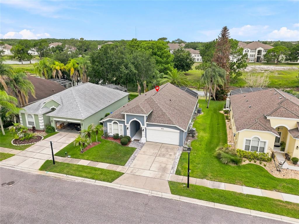 An aerial view shows a suburban house with a gray roof and a two-car garage — 2613 RUNYON CIRCLE, ORLANDO, FL