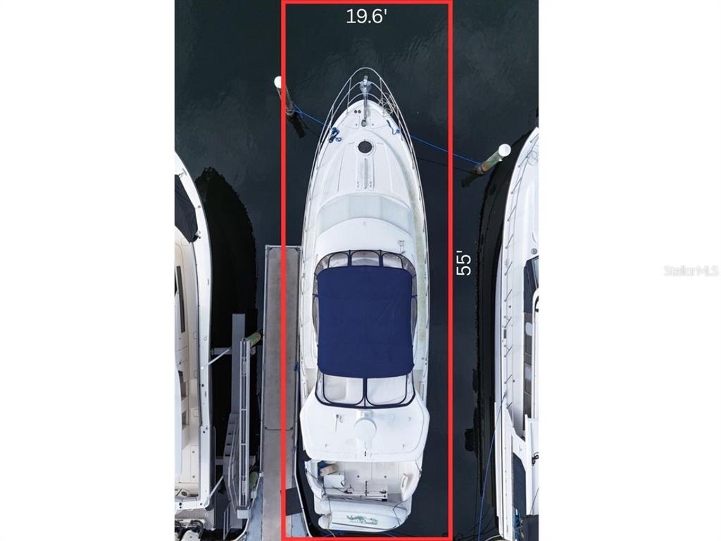An aerial view shows a boat docked in a slip marked with red dimensions — 102 RIVIERA DUNES WAY UNIT S-72, PALMETTO, FL