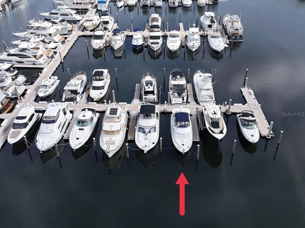 An aerial view shows a marina filled with numerous white motorboats docked in slips — 102 RIVIERA DUNES WAY UNIT S-72, PALMETTO, FL