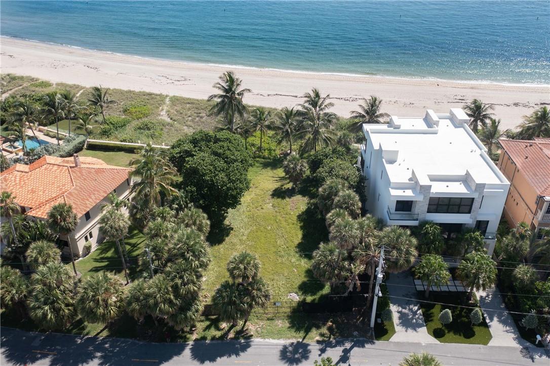 An aerial view shows a vacant beachfront lot situated between two large residential houses — 2100 Bay Drive, Pompano Beach FL 33062, POMPANO BEACH, FL