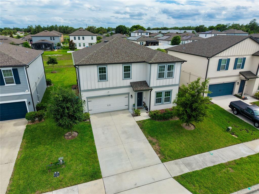 An aerial view shows a two-story suburban house with a white exterior and gray roof — 1187 PEARL TREE ROAD, DELTONA, FL
