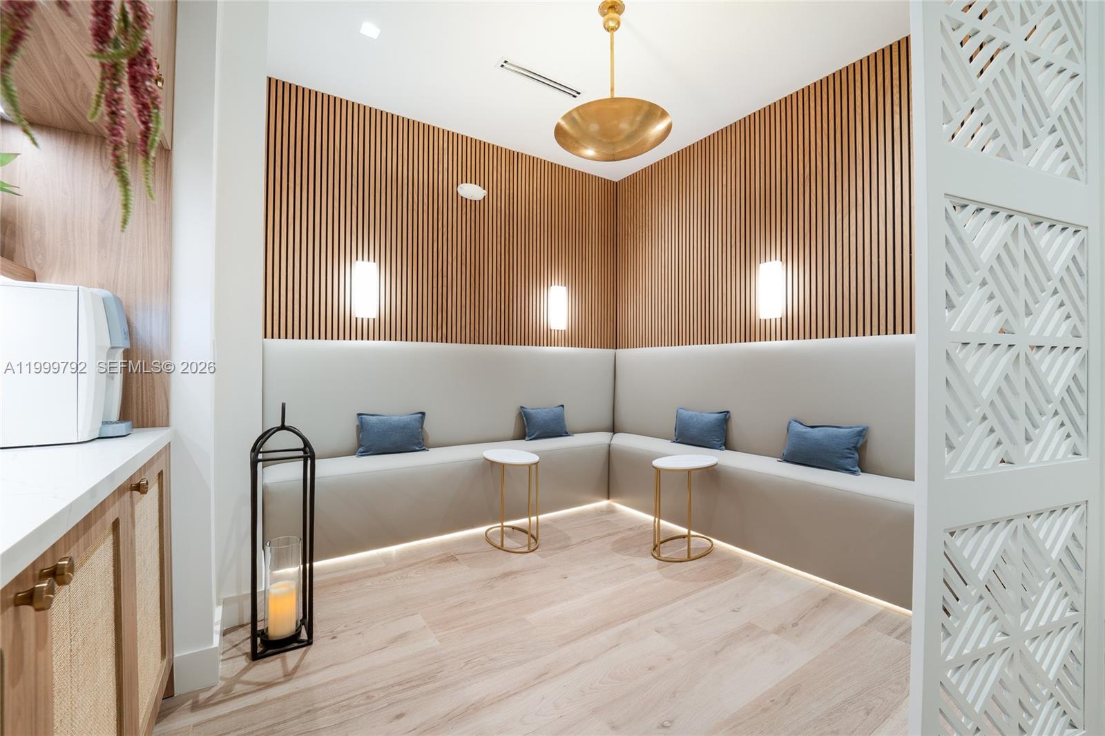 A modern lounge area features wood-slat walls, built-in bench seating, and gold accent lighting — 1340 S Dixie Hwy, Coral Gables FL 33146, CORAL GABLES, FL