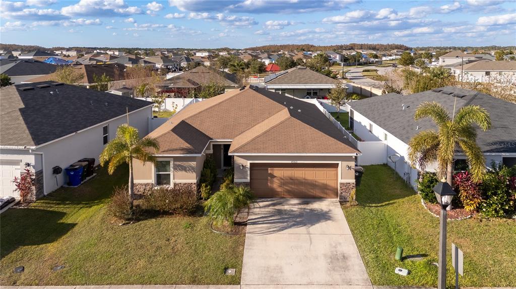An aerial view of a single-story suburban house with a brown roof and garage — 4563 ORCHARD GROVE ROAD, ST CLOUD, FL
