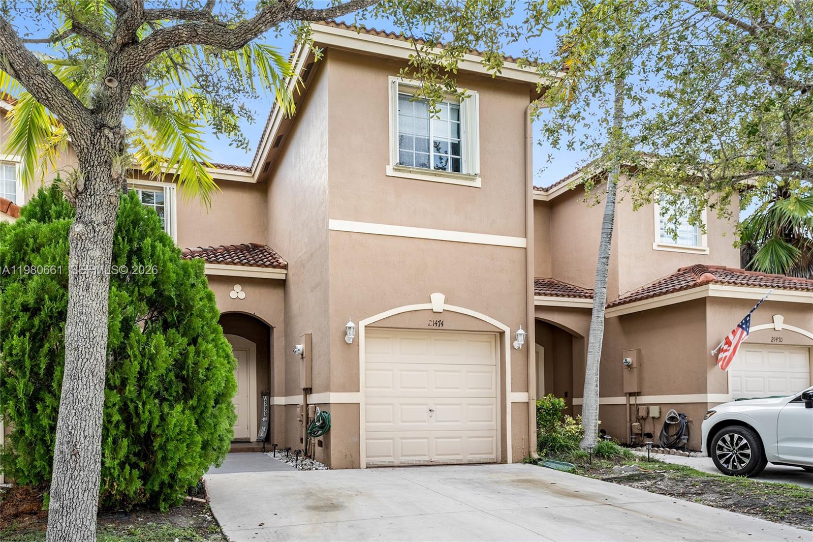 A two-story tan stucco townhouse with a garage and a concrete driveway — 21474 SW 85th Path, Cutler Bay FL 33189, CUTLER BAY, FL