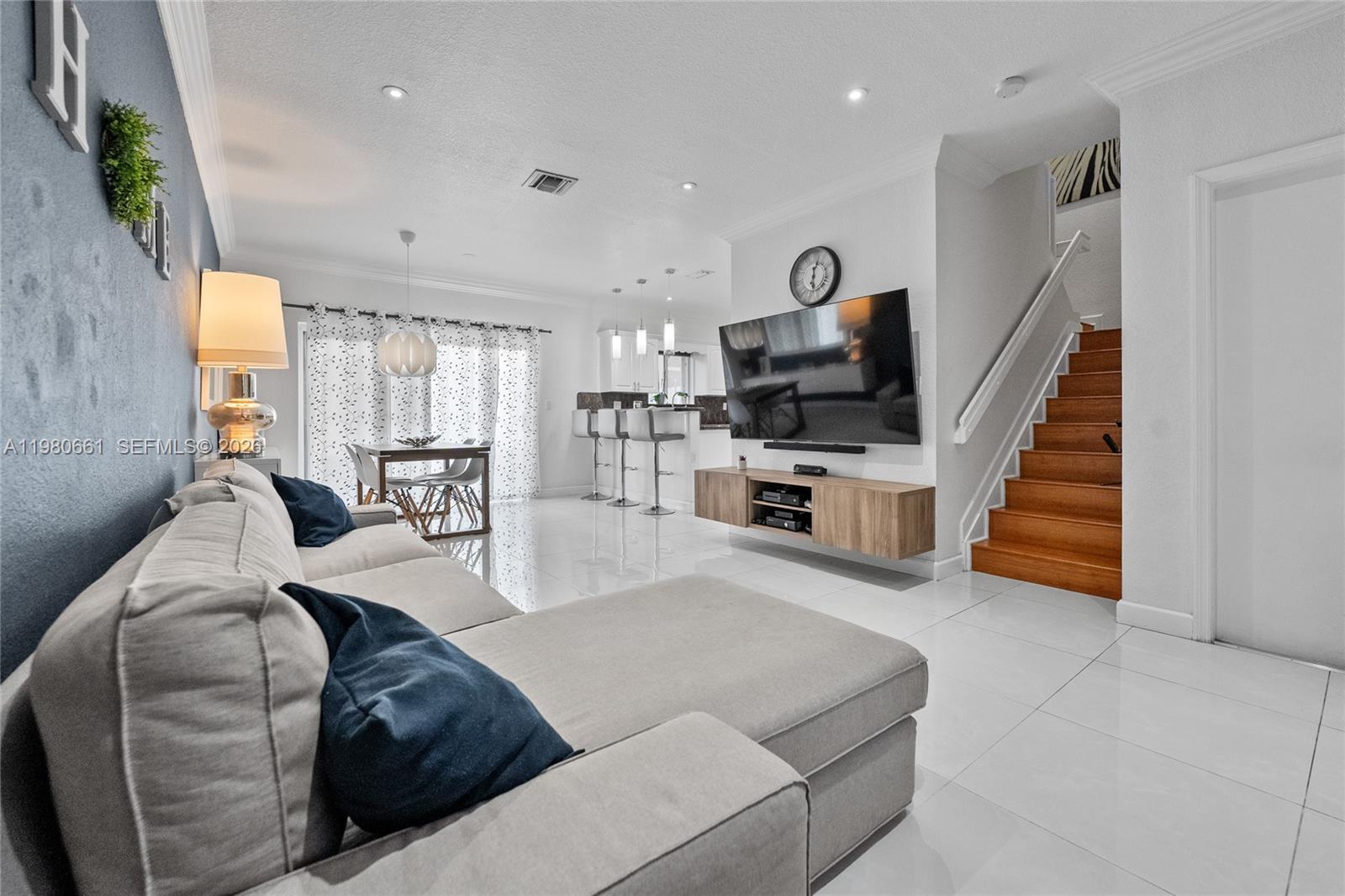 A living room features white tile floors, a sectional sofa, and a wall-mounted television — 21474 SW 85th Path, Cutler Bay FL 33189, CUTLER BAY, FL