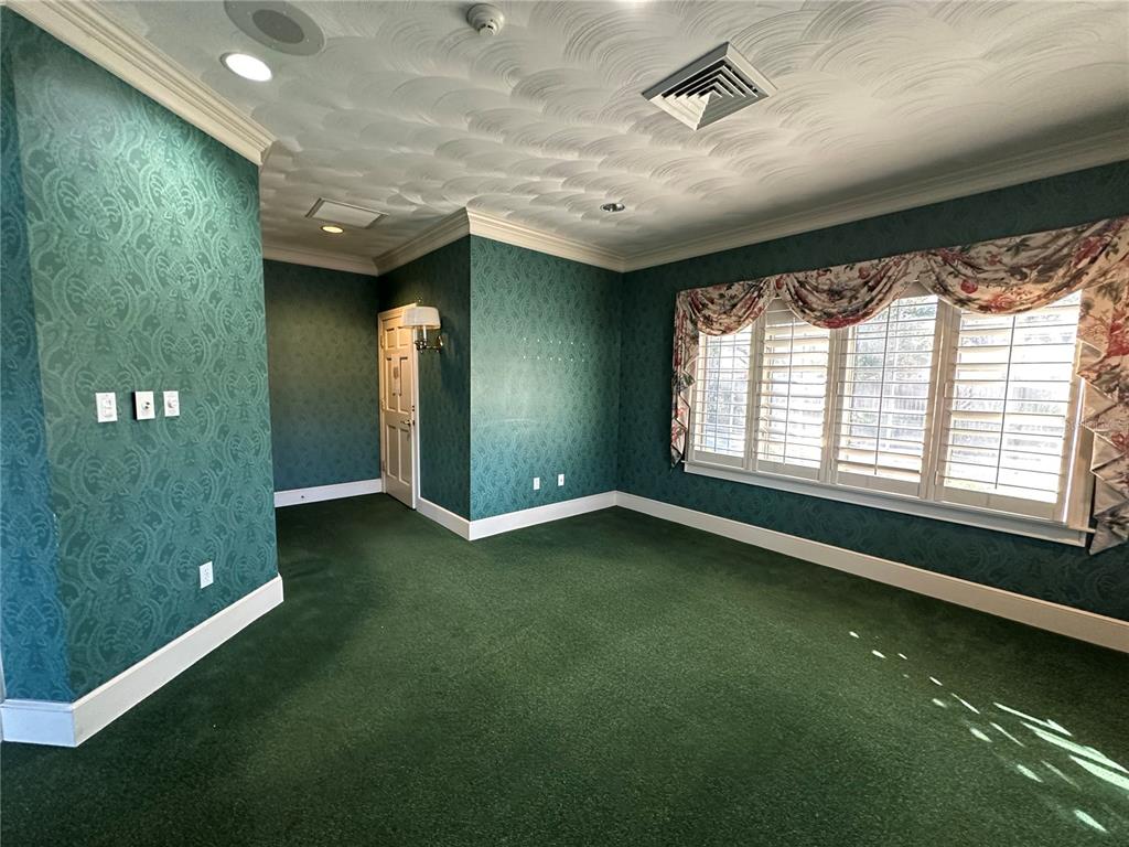 A room with green patterned wallpaper, green carpeting, and a large window with floral valances — 1005 PINELLAS STREET, CLEARWATER, FL