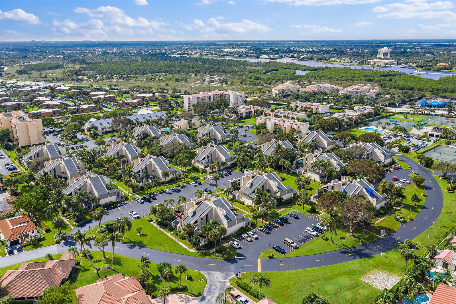 A swimming pool surrounded by lounge chairs and a patio with a table and umbrella — 1605 S Us Highway 1, Jupiter FL 33477, JUPITER, FL