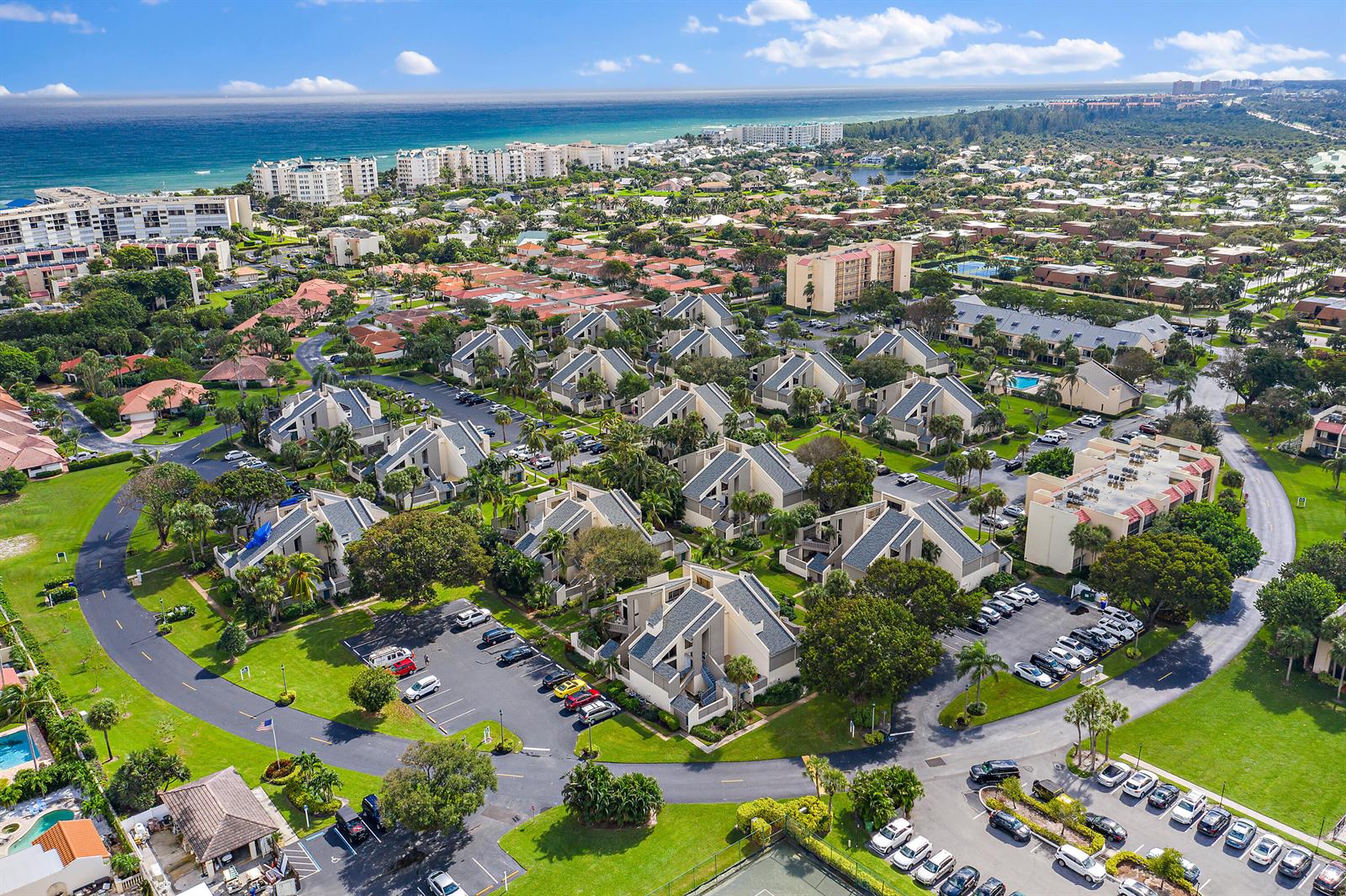 A two-story building exterior features a teal front door, parking spaces, and palm trees — 1605 S Us Highway 1, Jupiter FL 33477, JUPITER, FL