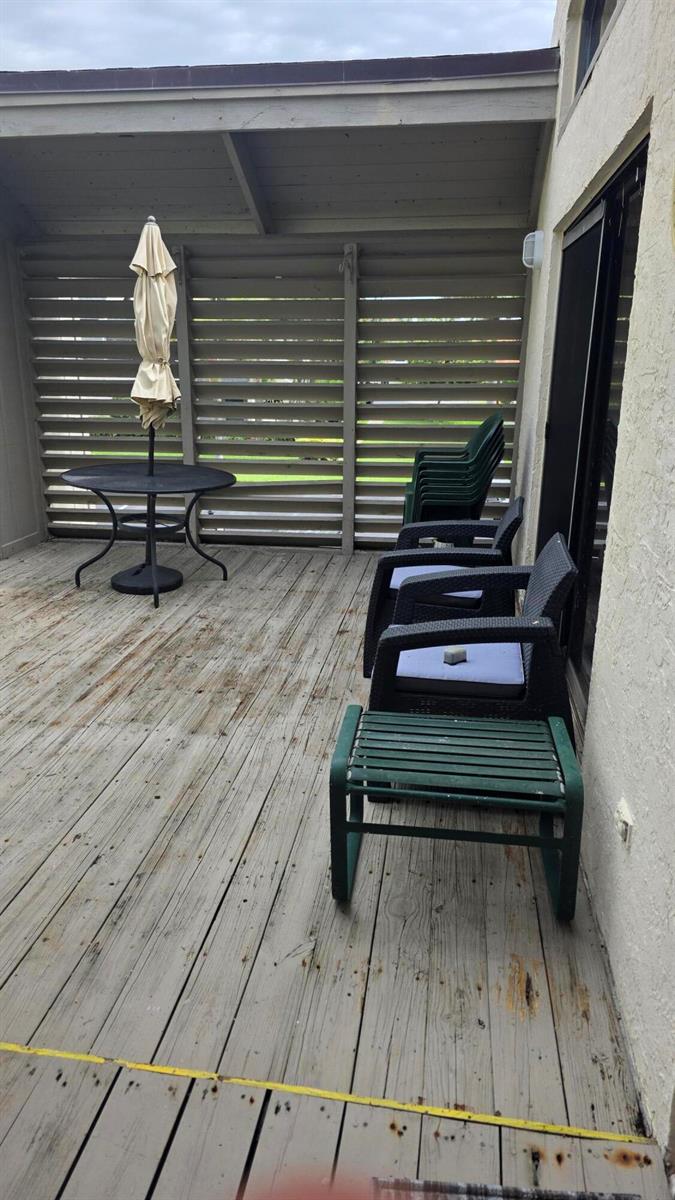 The exterior of a residential unit features a teal front door and a welcome sign — 1605 S Us Highway 1, Jupiter FL 33477, JUPITER, FL