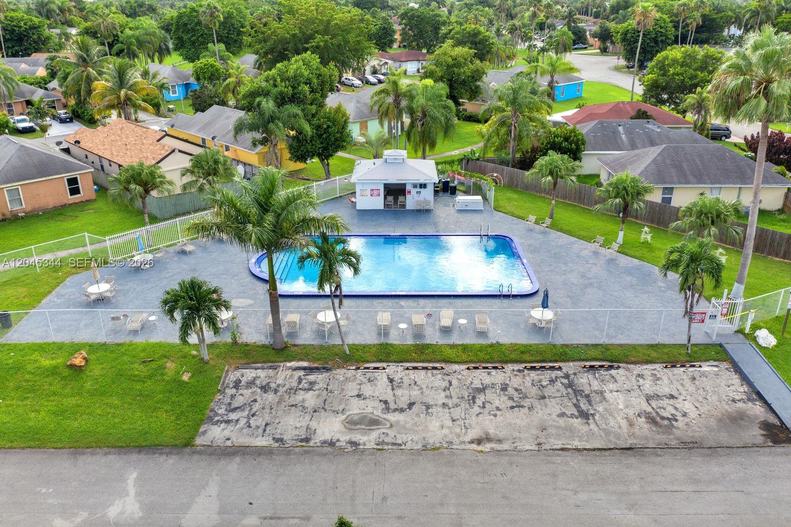 An aerial view shows a rectangular swimming pool with a pool house and surrounding patio — 768 SW 9th St, Florida City FL 33034, FLORIDA CITY, FL
