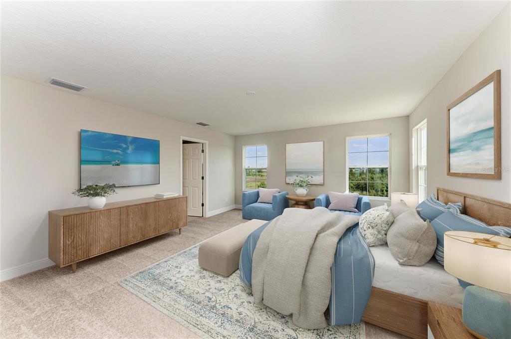 A bedroom features a bed, two blue armchairs, a television, and a wooden media console — 9723 SURREY ROSE DRIVE, SAN ANTONIO, FL