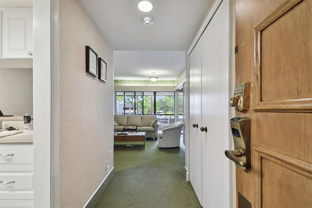 A small white kitchen features a refrigerator, stove, sink, and white cabinetry — 36750 US HIGHWAY 19 N UNIT 09208, PALM HARBOR, FL