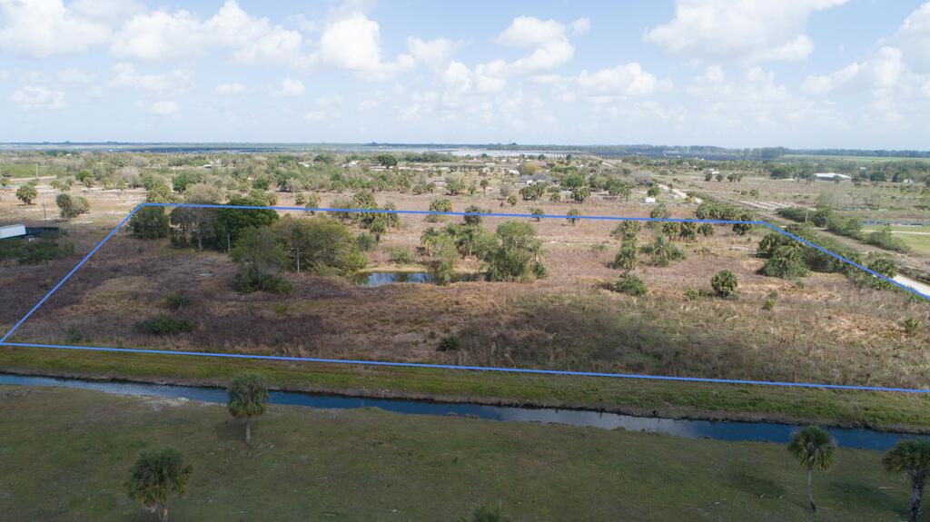 An aerial view shows a large, rectangular plot of undeveloped land outlined in blue — 20637 Simone Drive, Loxahatchee FL 33470, LOXAHATCHEE, FL