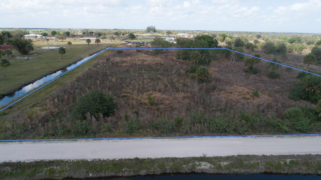 An aerial view shows a rectangular, undeveloped plot of land bordered by a dirt road — 20637 Simone Drive, Loxahatchee FL 33470, LOXAHATCHEE, FL