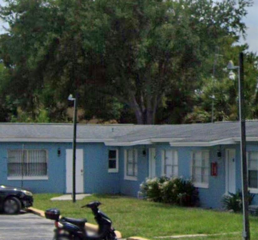 A blue single-story building with a flat roof and a front lawn — 3205 ORANGE CENTER BLVD, ORLANDO, FL